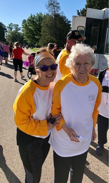 Patty poses with a resident at an outdoor event.